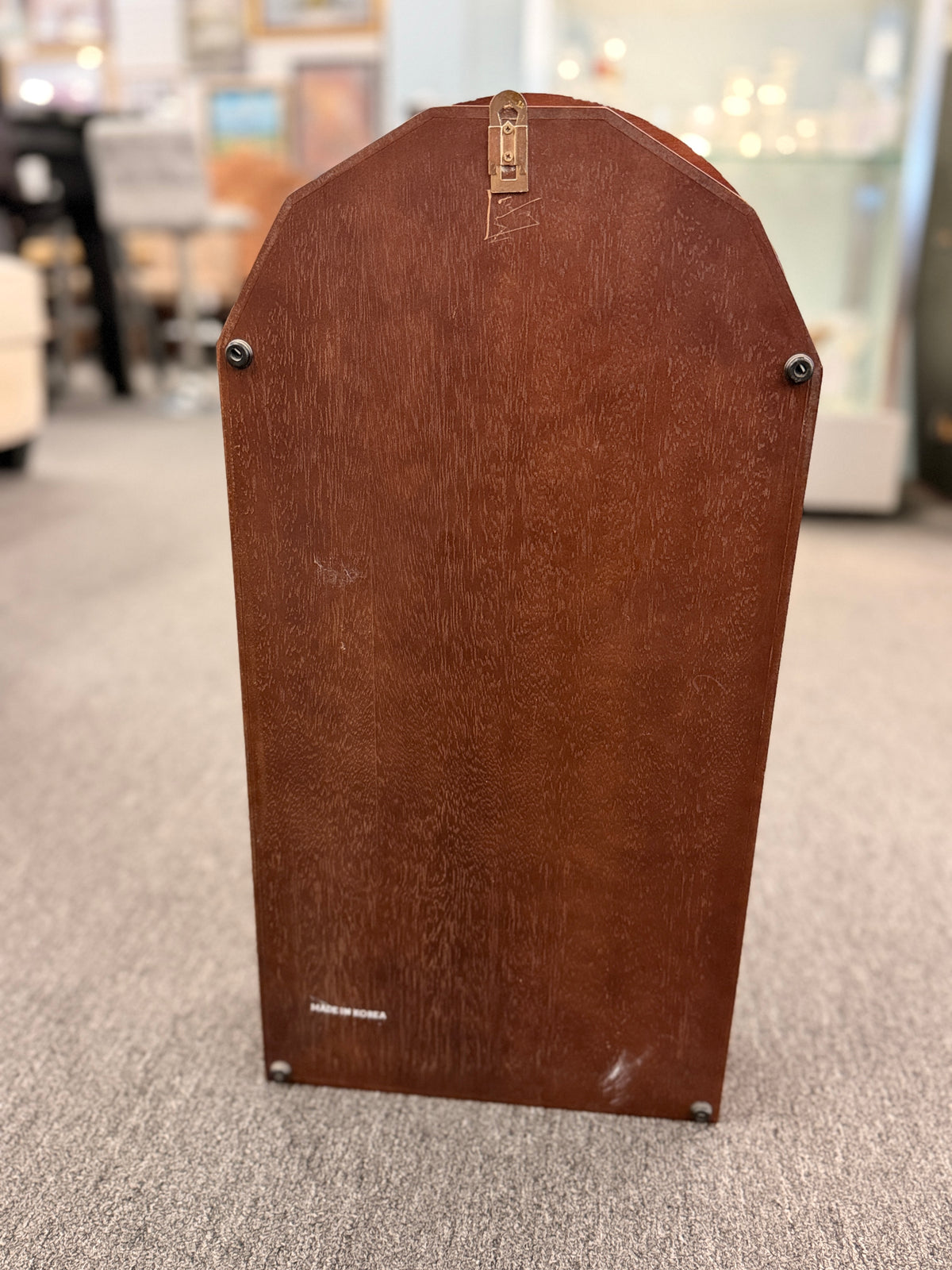 A traditional Waltham 31-day chime mantel clock in an arched cherry-finish wood case with a Roman numeral dial and brass pendulum in excellent condition.