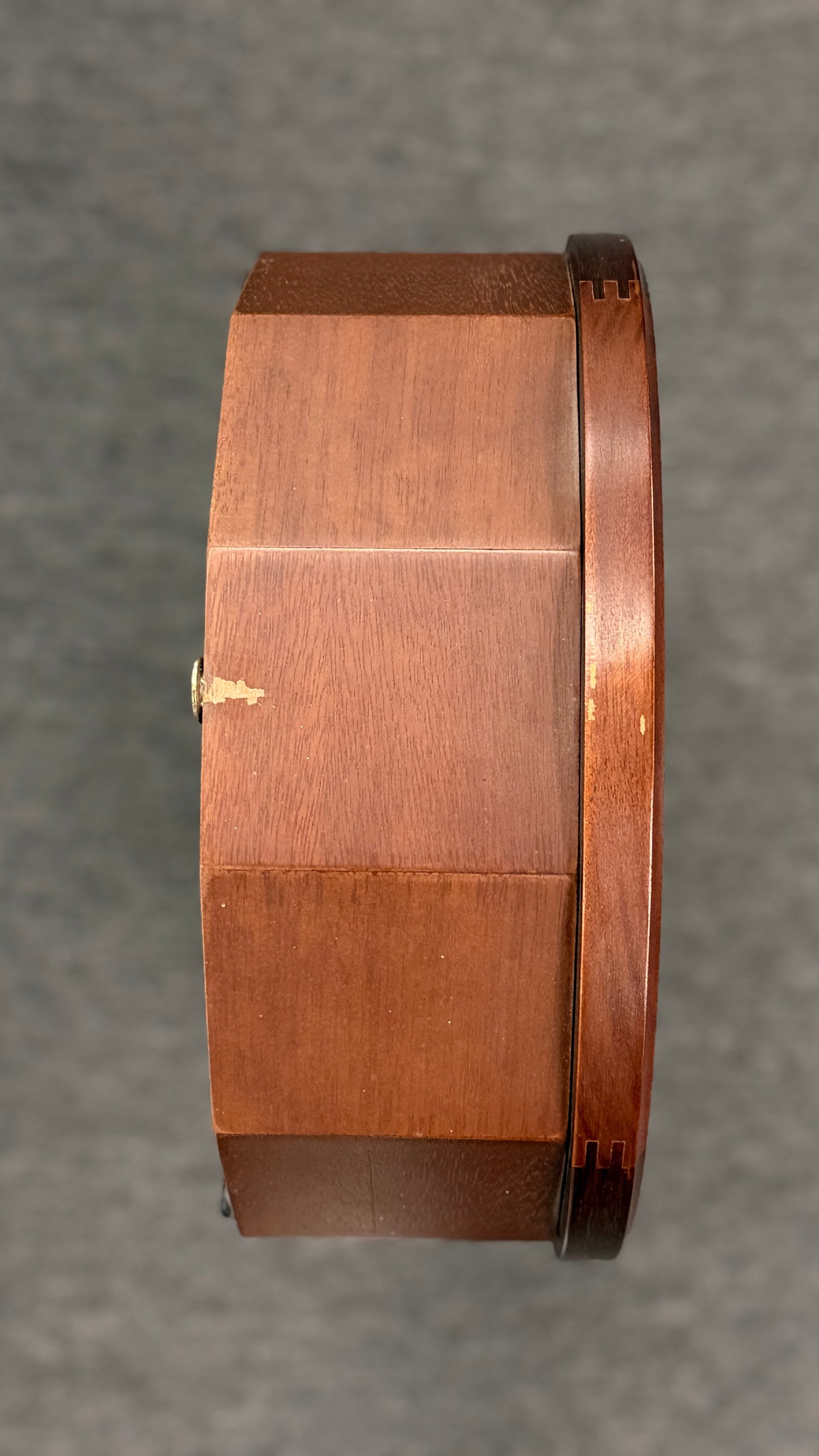A traditional Waltham 31-day chime mantel clock in an arched cherry-finish wood case with a Roman numeral dial and brass pendulum in excellent condition.