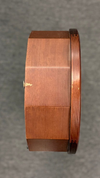 A traditional Waltham 31-day chime mantel clock in an arched cherry-finish wood case with a Roman numeral dial and brass pendulum in excellent condition.
