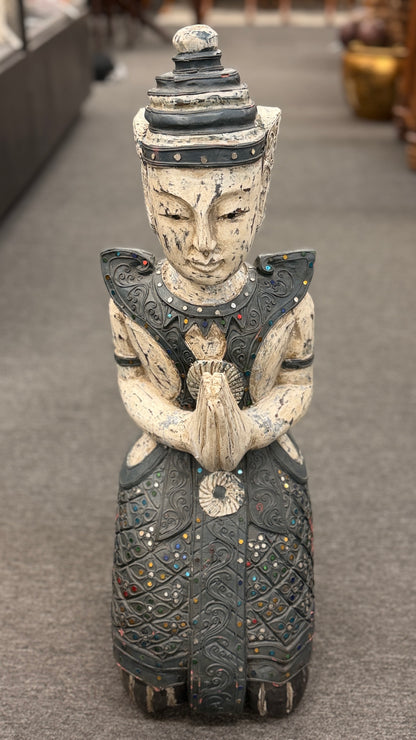 Traditional kneeling Buddhist or Southeast Asian deity statue finished in a distressed weathered white and black wash with intricate mirrored and jeweled accents in excellent condition.