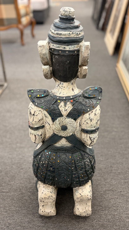 Traditional kneeling Buddhist or Southeast Asian deity statue finished in a distressed weathered white and black wash with intricate mirrored and jeweled accents in excellent condition.
