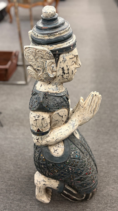 Traditional kneeling Buddhist or Southeast Asian deity statue finished in a distressed weathered white and black wash with intricate mirrored and jeweled accents in excellent condition.